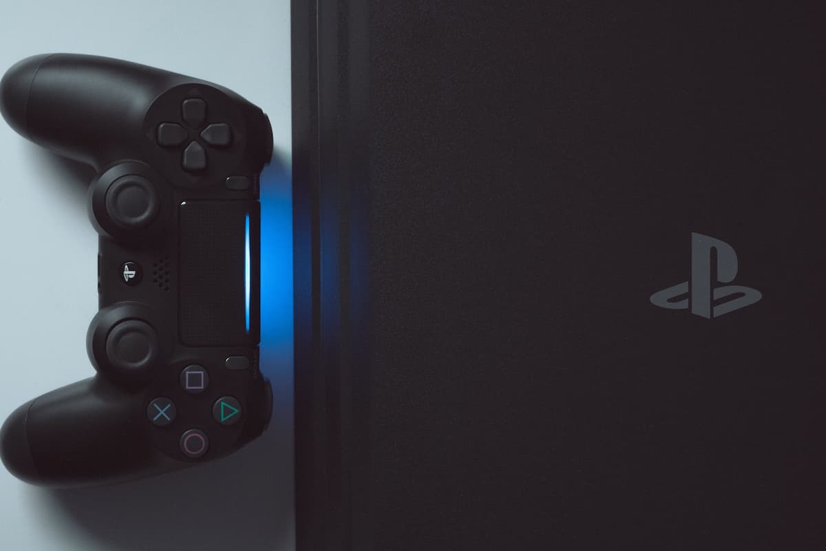 Flat lay photo of Playstation 4 on a white surface.