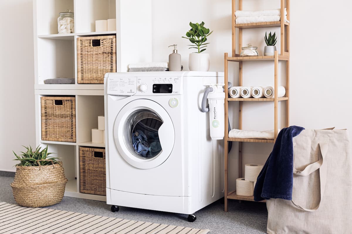 A clothes dryer inside a laundry room. 