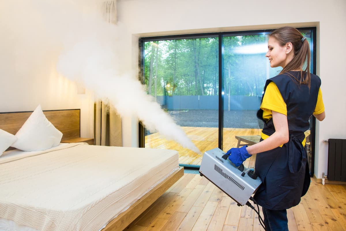 A woman exterminator treats the house with hot steam.