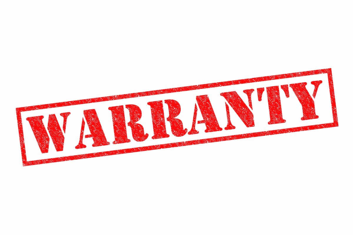 Illustration photo of WARRANTY red rubber stamp over a white background.
