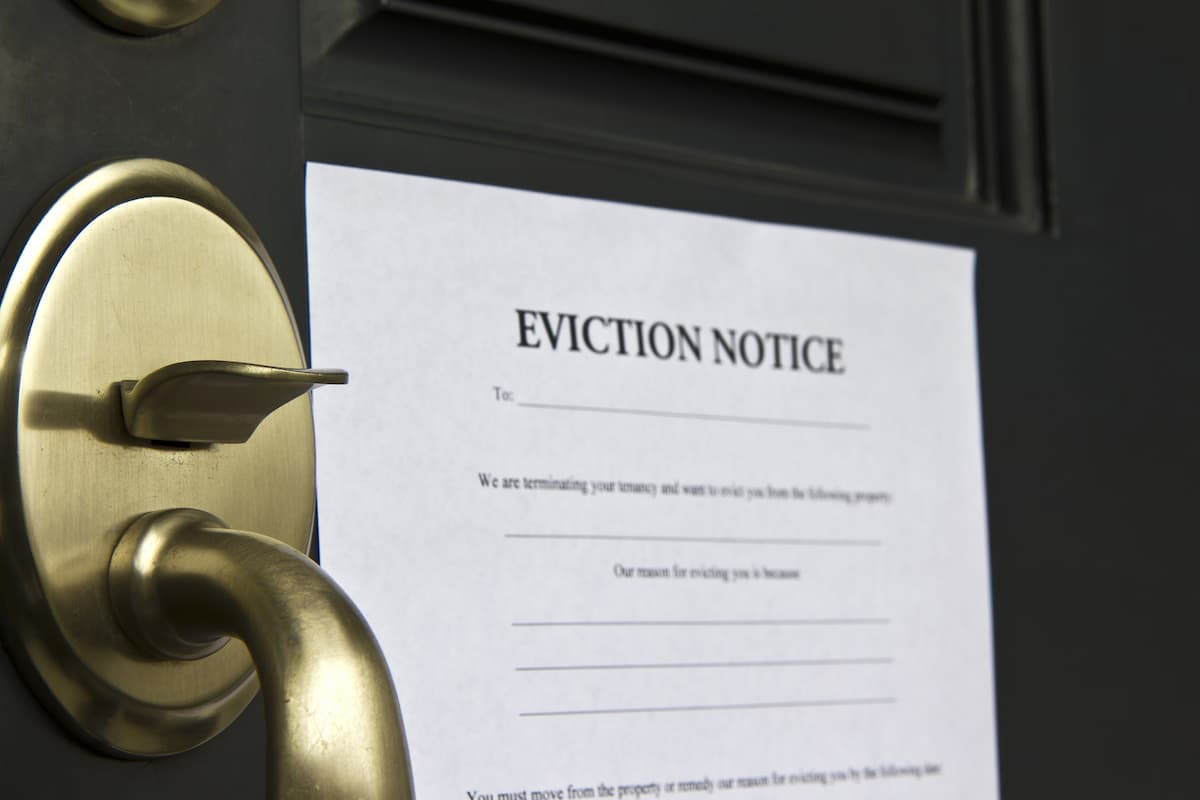 An eviction notice letter posted on the front of the door. 