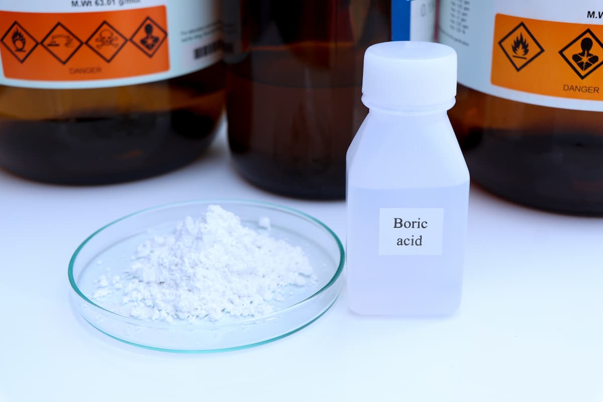 A bottle of boric acid on a white table.