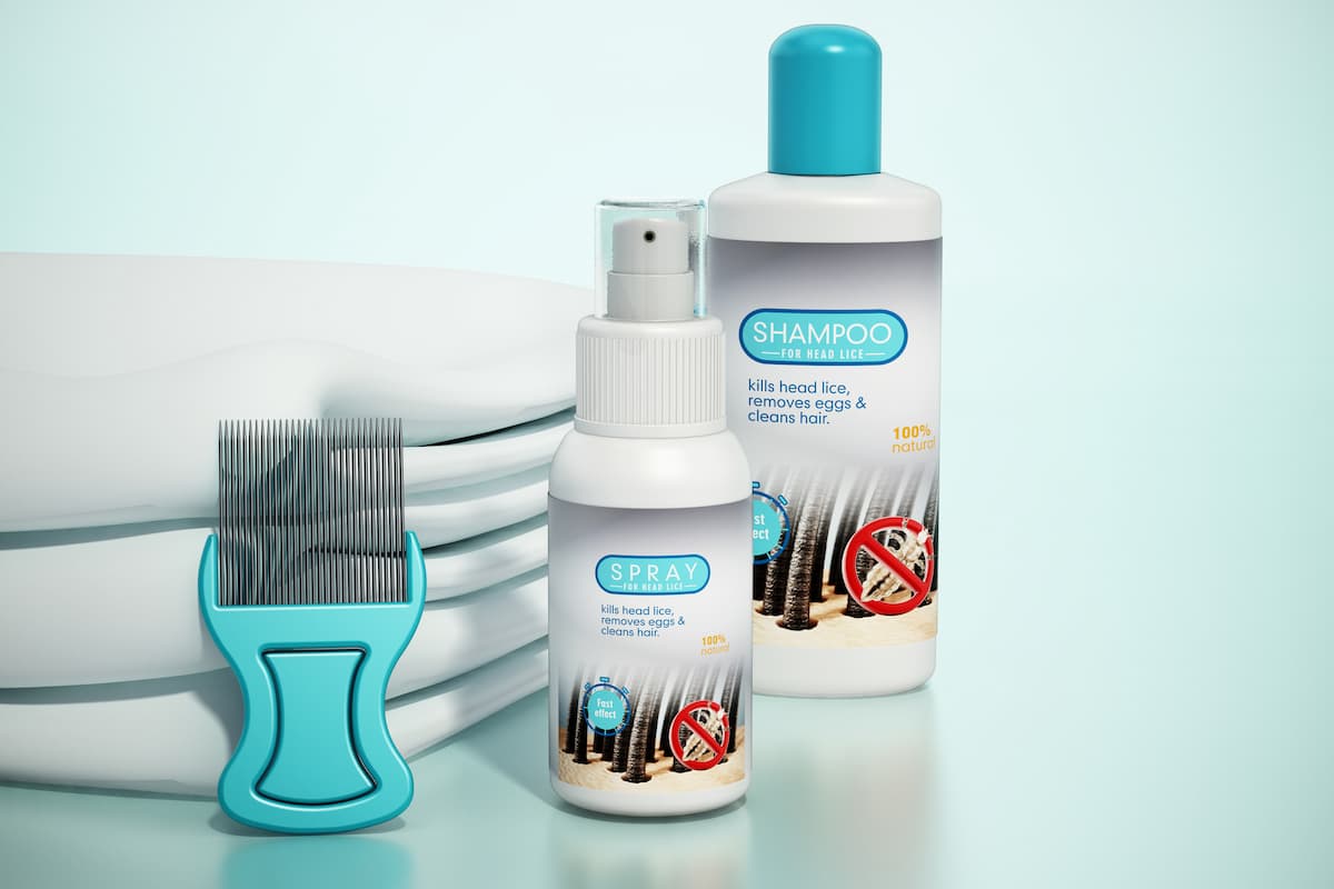 A bottle of head lice shampoo, spray, lice comb, and towel on a white surface. 