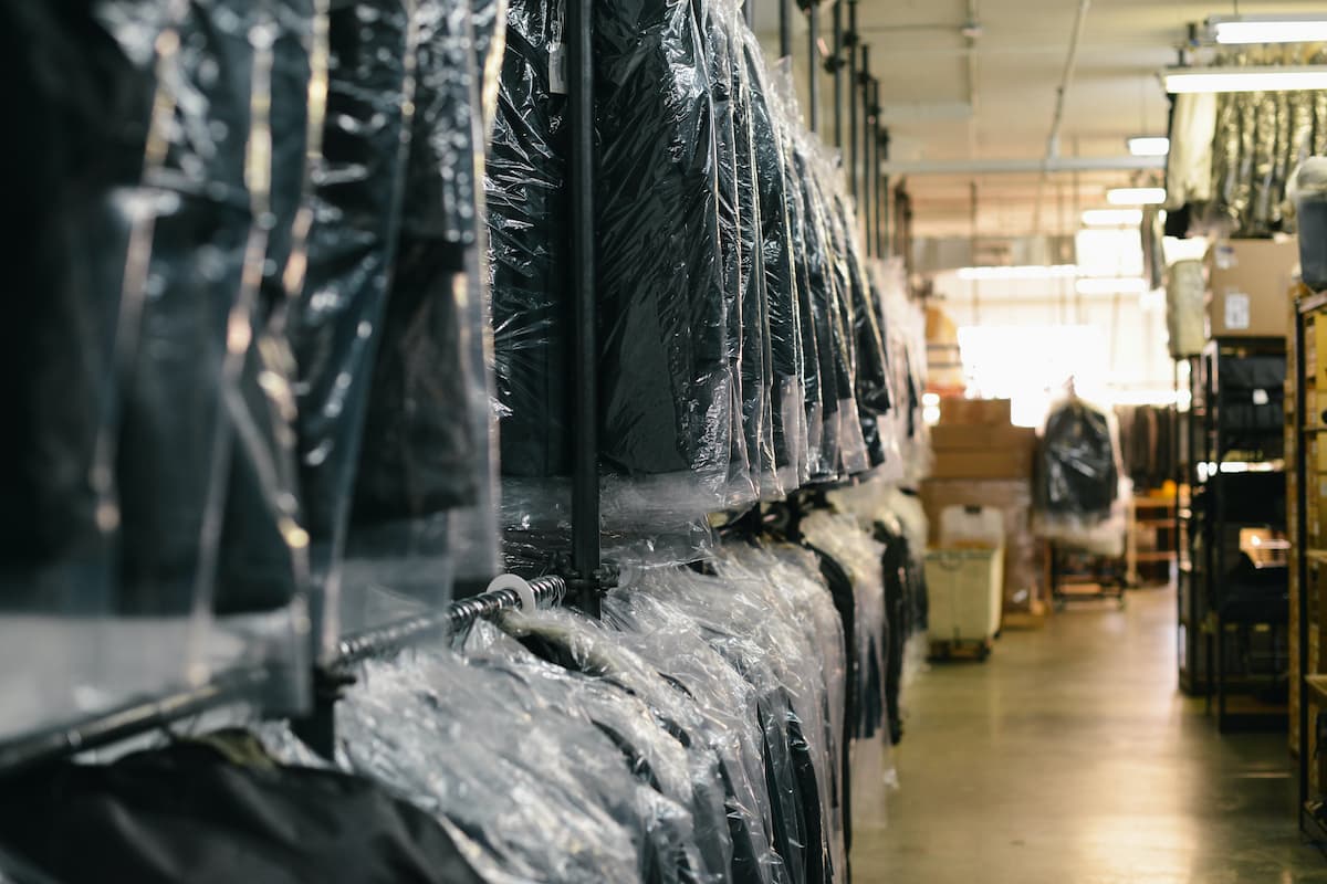 Dry cleaned clothes inside the dry cleaner. 