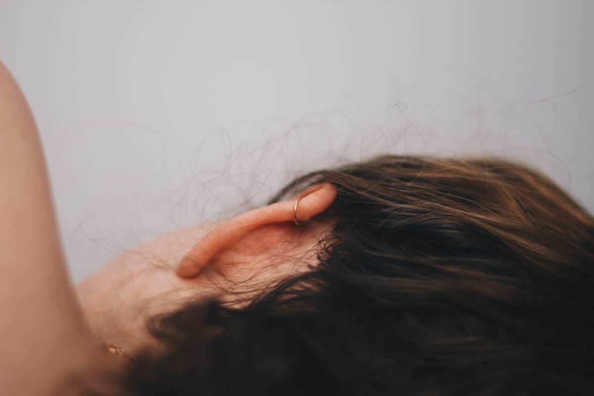 Photo of the back of a woman's ear. 