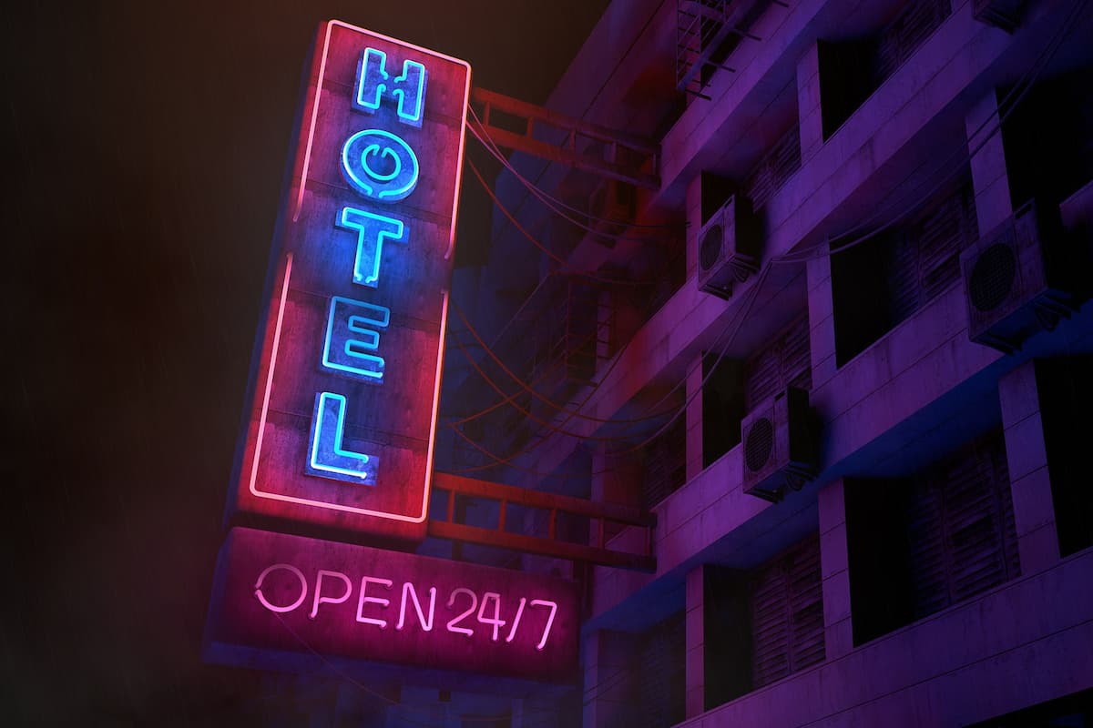 A neon light signage of an old hotel.