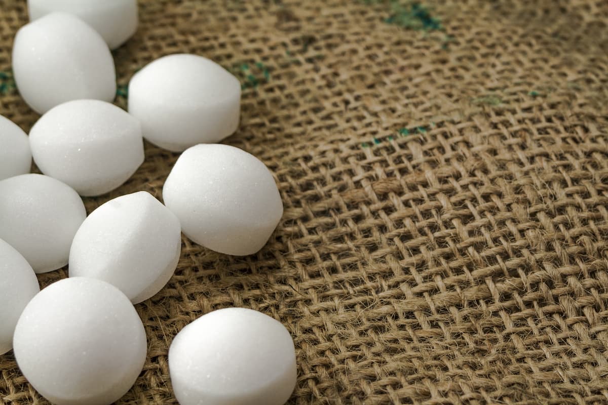 Close-up photo of mothballs on a sackcloth. 