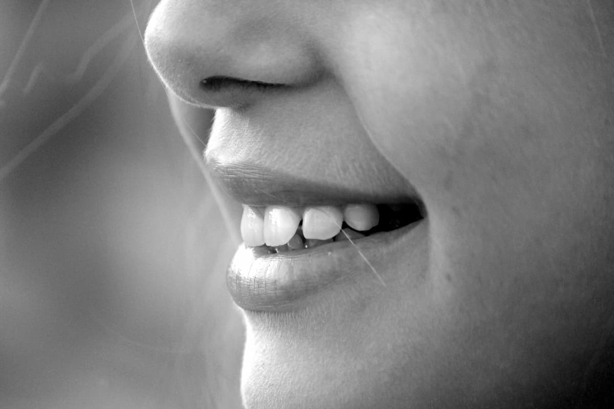 Black and white close-up photo of a woman's mouth and nose. 