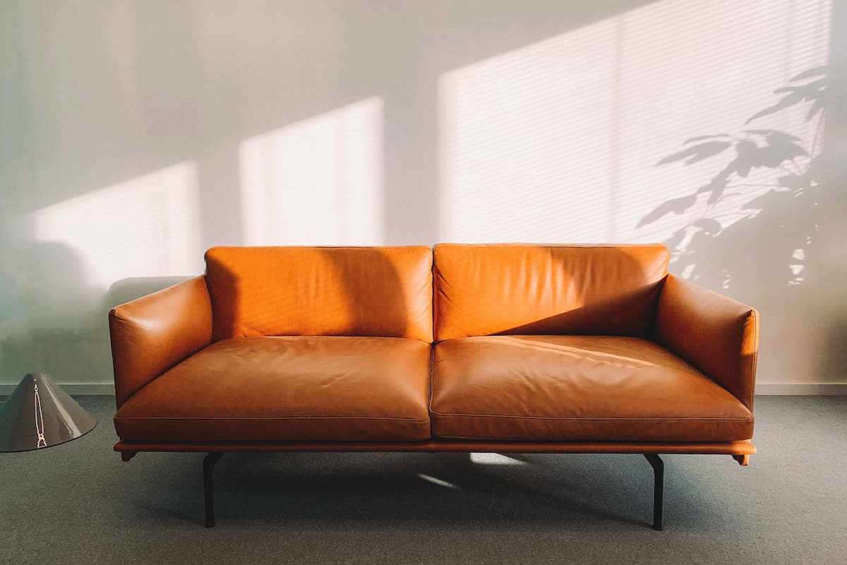An orange leather sofa in the living room. 